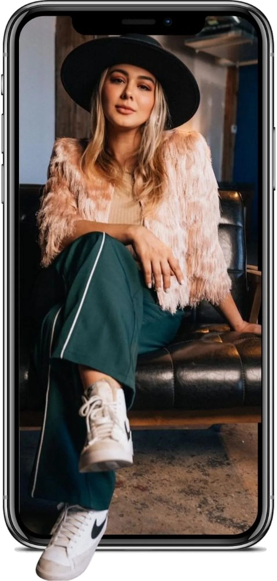 Cata Balzano sitting inside an iPhone, one leg stepping out of the screen.